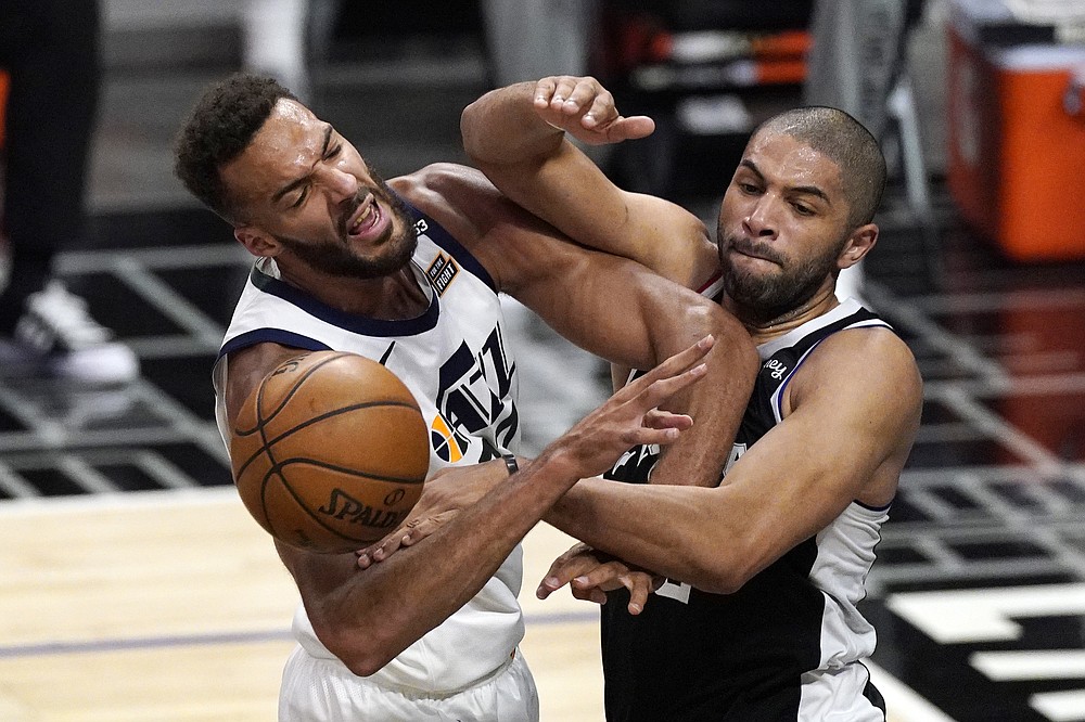 Utah Jazz center Rudy Gobert, left, blocks a pass intended for Los Angeles Clippers forward Nicolas Batum during the second half of Game 3 of a second-round NBA basketball playoff series Saturday, June 12, 2021, in Los Angeles. (AP Photo/Mark J. Terrill)