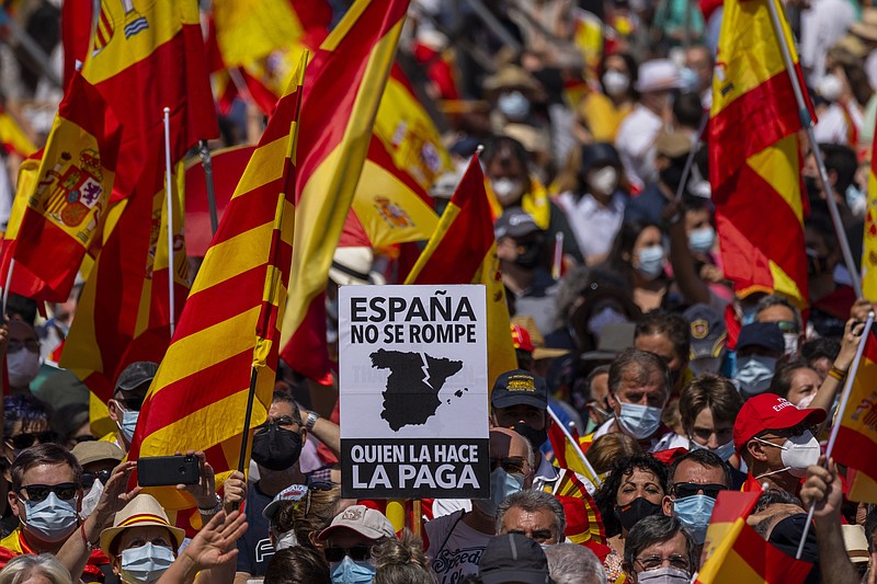Thousands gather during a protest against the Spanish government's plan to issue pardons to a dozen imprisoned Catalan separatist leaders, Madrid, Sunday, 13 June, 2021. The demonstration has been organized by a civil society group in defense of the nation's unity that chose to hold it at a central square that has become popular for far-right political rallies. The banner reads in Spanish "You can't break Spain. Whoever does it, will pay for it.". (AP Photo/Bernat Armangue)
