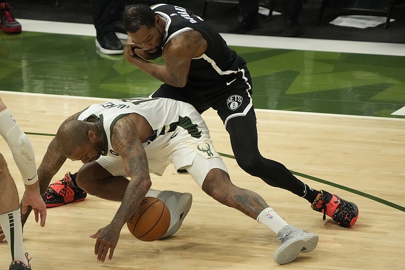 Milwaukee Bucks' P.J. Tucker steals the ball from Brooklyn Nets' Kevin Durant during the first half of Game 4 of the NBA Eastern Conference basketball semifinals game Sunday, June 13, 2021, in Milwaukee. (AP Photo/Morry Gash)