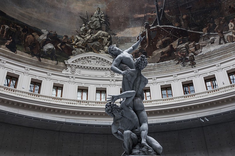 A replica of the 16th-century sculptor Giambologna’s “Rape of the Sabine Women” is one of nine wax figures that constitute Urs Fischer’s 2011-2020 work “Untitled” at the “Ouverture” exhibition in the Bourse de Commerce in Paris. Paris is waking up from months of stringent restrictions, and welcoming travelers. (Bloomberg/Jeanne Frank)
