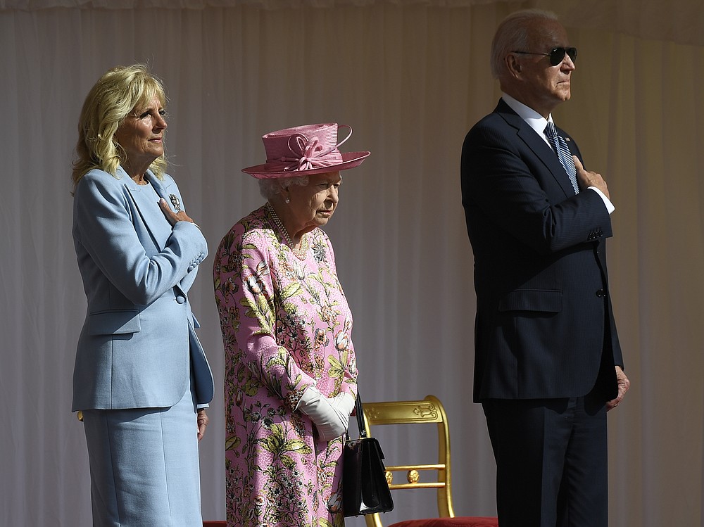 Britain's Queen Elizabeth II stands with US President Joe Biden and First Lady Jill Biden as they listen to the US national anthem at Windsor Castle near London, Sunday, June 13, 2021. (AP Photo/Alberto Pezzali)