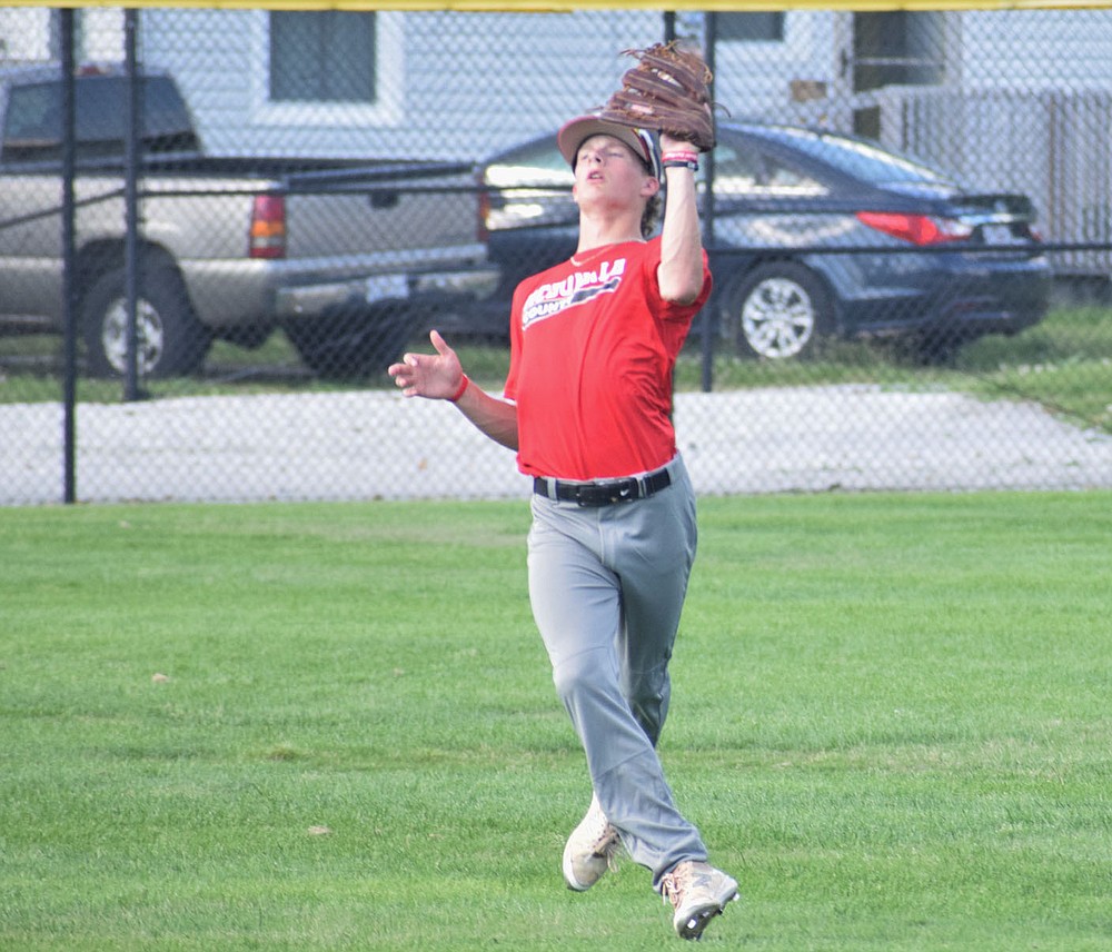 RICK PECK/SPECIAL TO MCDONALD COUNTY PRESS McDonald County center fielder Jack Parnell catches a fly ball during Webb City's 13-2 win in an 8-on-8 league game at Joe Becker Stadium in Joplin.