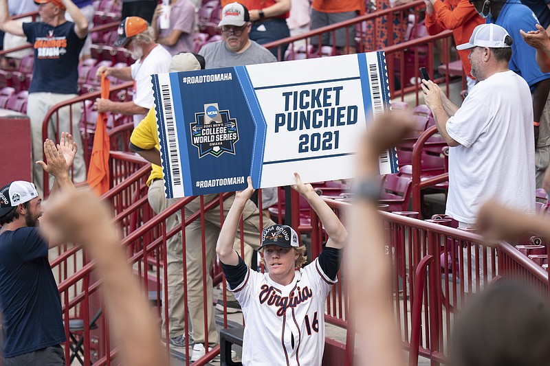 Virginia's Andrew Abbott holds up a sign for the College World Series after an NCAA college baseball tournament super regional game against Dallas Baptist, Monday, June 14, 2021, in Columbia, S.C. (AP Photo/Sean Rayford)