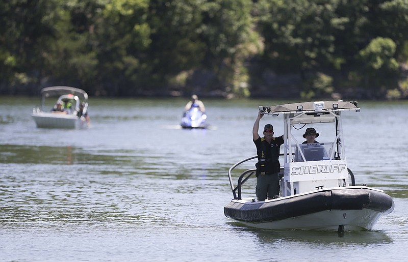 Emergency responders approach a dock by boat, Monday, June 14, 2021 at the Prairie Creek Marina in Rogers. Officials searched for a possible drowning victim on Beaver Lake. Check out nwaonline.com/210615Daily/ for today's photo gallery. 
(NWA Democrat-Gazette/Charlie Kaijo)