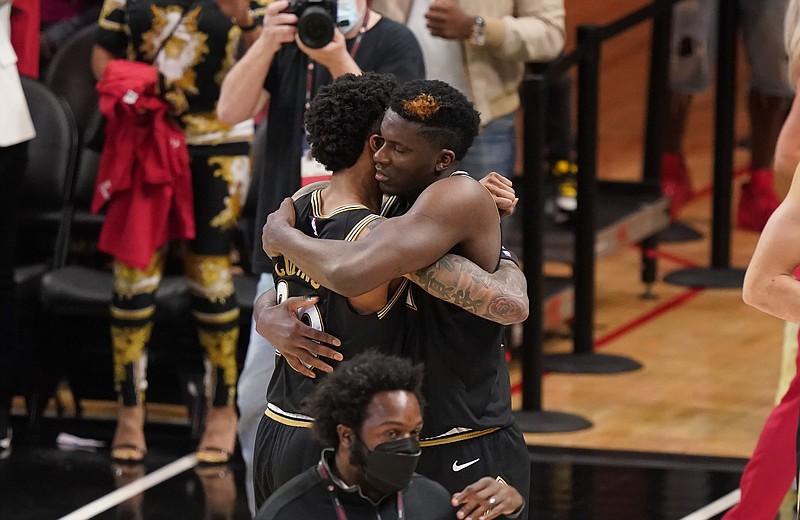 Atlanta Hawks' John Collins, left, hugs teammate Clint Capela, right, after Game 4 of a second-round NBA basketball playoff series against the Philadelphia 76ers, Monday, June 14, 2021, in Atlanta. (AP Photo/Brynn Anderson)