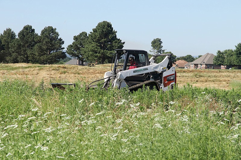 LYNN KUTTER ENTERPRISE-LEADER
A Farmington public works employee uses a skid steer to mow the grass and brush at the Valley View Golf Course. The city has received many complaints about the tall grass. This is the second time, city employees have mowed the property.