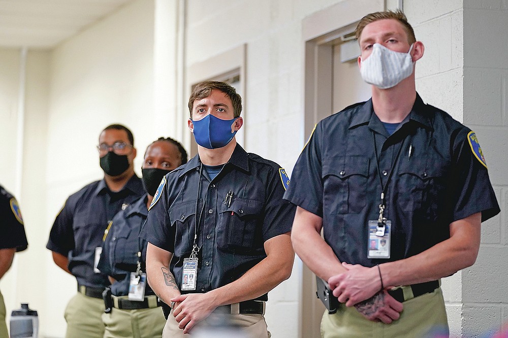 In this Sept. 9, 2020, photo Zachary Ruhling, center, a cadet in the Baltimore Police Academy, watches a video presentation during a class session focusing on procedural justice in Baltimore. (AP Photo/Julio Cortez)