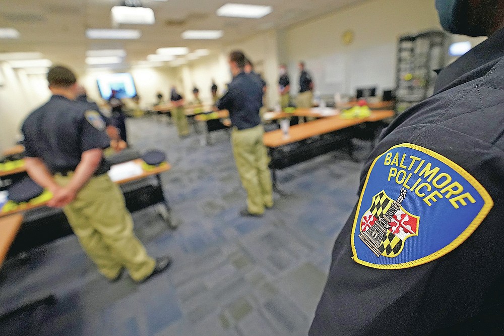 In this Sept. 9, 2020, photo Baltimore Police Academy cadets listen to an instructor during a class focusing on procedural justice in Baltimore. (AP Photo/Julio Cortez)