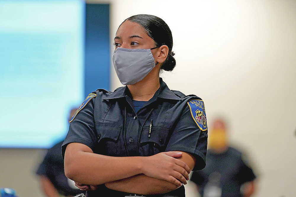 In this Sept. 9, 2020, photo Kaley Garced, a cadet in the Baltimore Police Department, listens to an instructor during a class session focusing on procedural justice in Baltimore. (AP Photo/Julio Cortez)