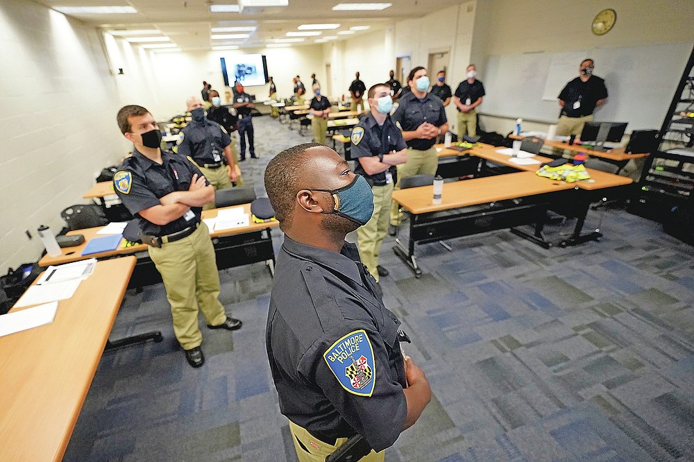 In this Sept. 9, 2020, photo Baltimore Police Academy cadets watch a video presentation during a class session focusing on procedural justice in Baltimore. (AP Photo/Julio Cortez)