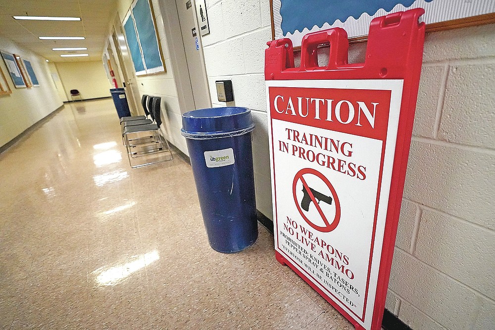 In this Sept. 9, 2020, photo a sign is seen in the hallway near classrooms where Baltimore Police Academy cadets attend classes in Baltimore. (AP Photo/Julio Cortez)