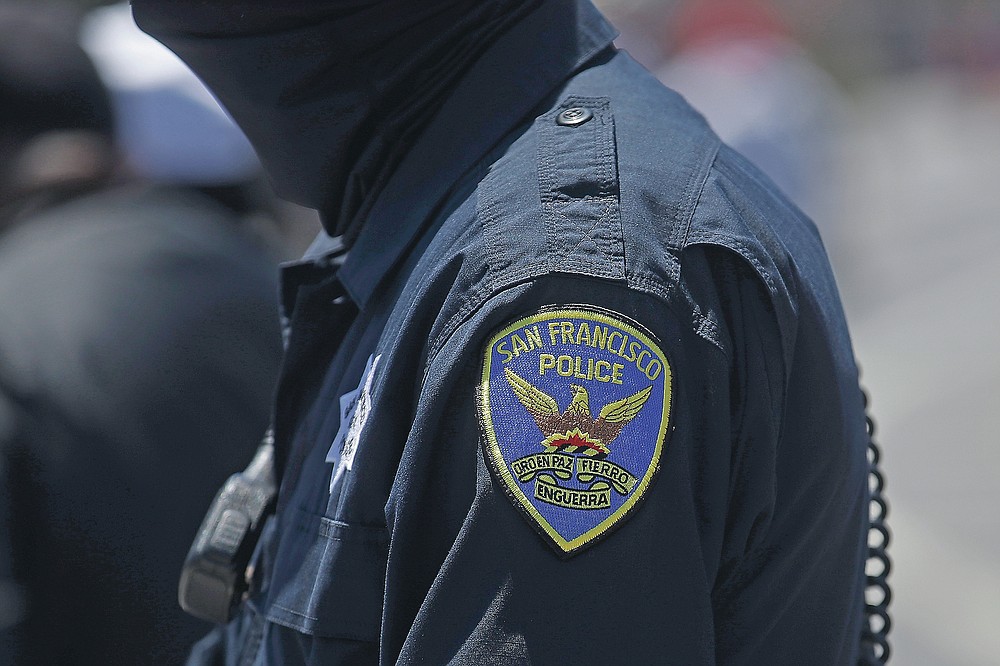 FILE - In this July 7, 2020, file photo a San Francisco Police Department patch is shown on an officer's uniform in San Francisco. Law enforcement agencies across the country experienced a wave of retirements and departures and are struggling to recruit the next generation of police officers in the year since George Floyd was killed by a cop. And amid the national reckoning on policing, communities are questioning who should become a police officer today. (AP Photo/Jeff Chiu, File)