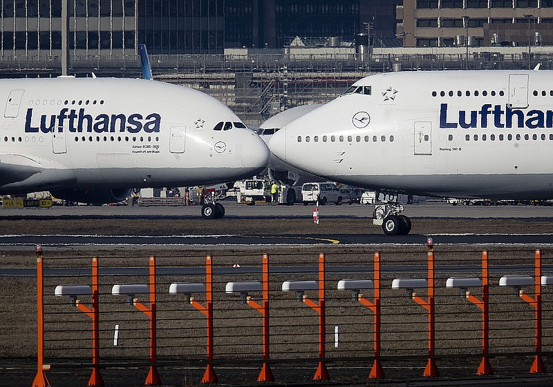 FILE - In this Feb.14, 2019 file photo, an Airbus A380, left, and a Boeing 747, both from Lufthansa airline pass each other at the airport in Frankfurt, Germany. The United States and the European Union on Tuesday appeared close to clinching a deal to end a damaging dispute over subsidies to Airbus and Boeing and lift billions of dollars in punitive tariffs. (AP Photo/Michael Probst, File)