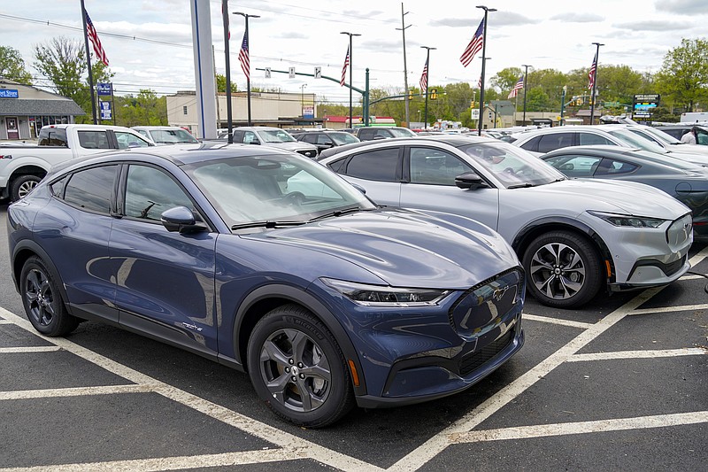 A pair of 2021 Ford Mustang Mach E are displayed for sale at a Ford dealer on Thursday, May 6, 2021, in Wexford, Pa. Retail sales fell in May, dragged down by a decline in auto sales, likely due to fewer cars being made amid a pandemic-related shortage of chips. Sales dropped a seasonal adjusted 1.3% in May from the month before, the U.S. Commerce Department said Tuesday, June 15. (AP Photo/Keith Srakocic)