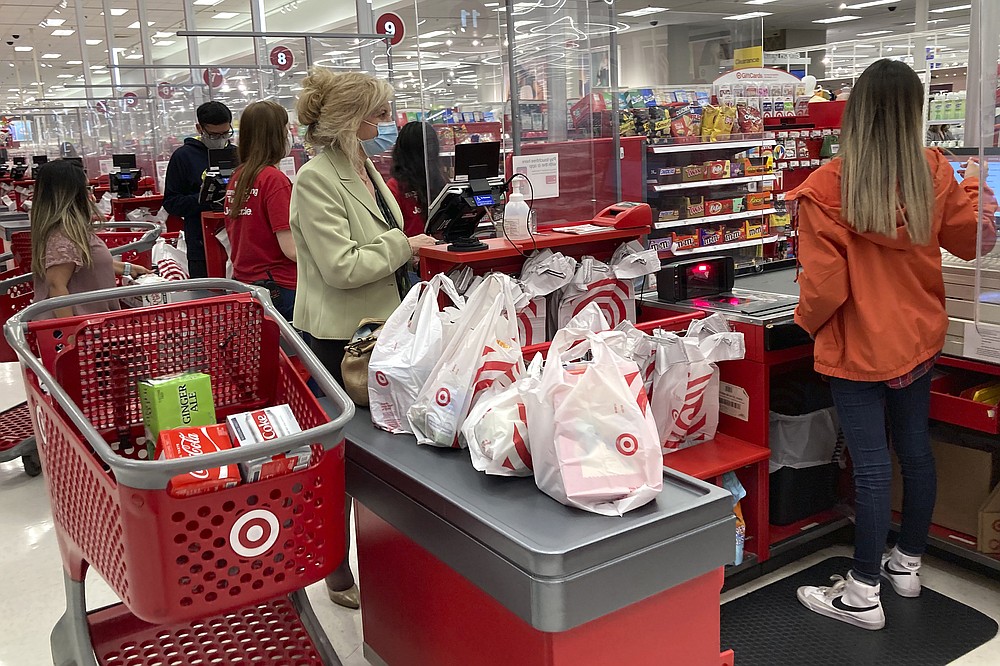 A customer wears a mask as she waits to get a receipt at a register in a Target store in Vernon Hills, Ill., Sunday, May 23, 2021. Retail sales fell in May, dragged down by a decline in auto sales, likely due to fewer cars being made amid a pandemic-related shortage of chips. Sales dropped a seasonal adjusted 1.3{c9ada2945935efae6c394ba146a2811ce1f3bfd992f6399f3fbbb16c76505588} in May from the month before, the U.S. Commerce Department said Tuesday, June 15. (AP Photo/Nam Y. Huh)