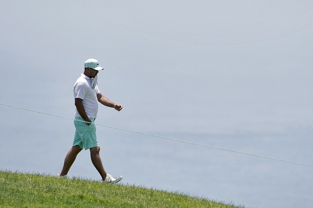 Brooks Koepka walks to the fourth tee during a practice round of the U.S. Open Golf Championship, Tuesday, June 15, 2021, at Torrey Pines Golf Course in San Diego. (AP Photo/Jae C. Hong)