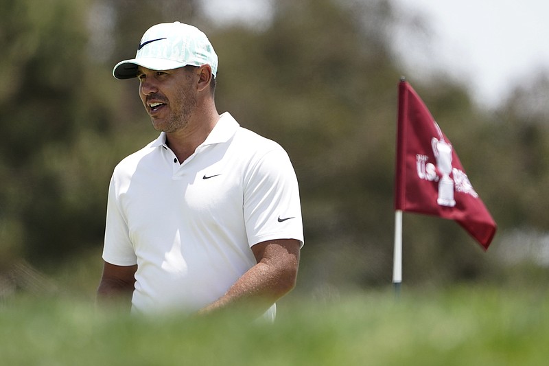 Brooks Koepka walks on the first green during a practice round of the U.S. Open Golf Championship, Tuesday, June 15, 2021, at Torrey Pines Golf Course in San Diego. (AP Photo/Jae C. Hong)