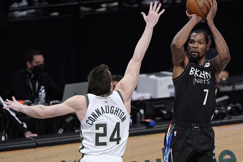 Brooklyn Nets forward Kevin Durant (7) shoots as Milwaukee Bucks guard Pat Connaughton (24) defends during the fourth quarter of Game 5 of a second-round NBA basketball playoff series Tuesday, June 15, 2021, in New York. (AP Photo/Kathy Willens)