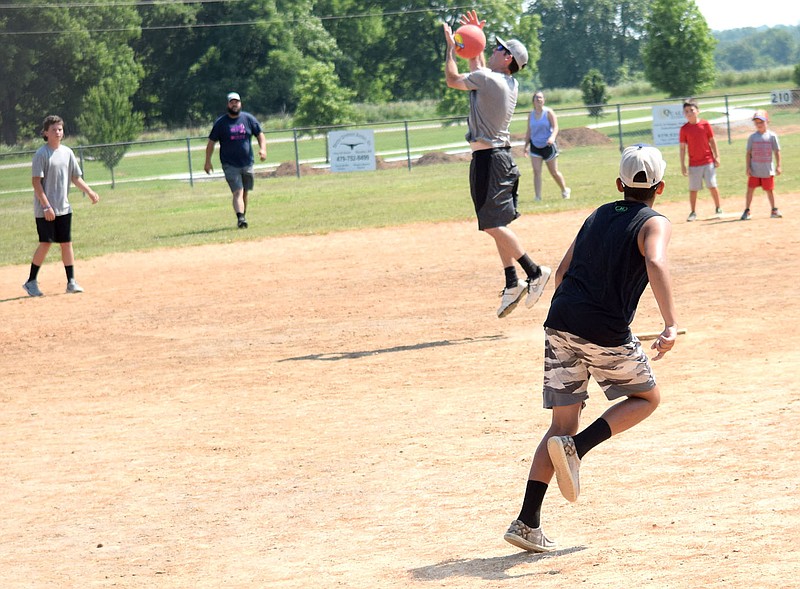 Westside Eagle Observer/MIKE ECKELS

After the big softball matchup, a Hickson kicker launches the ball into the hands of the Wilkins pitcher during a kickball contest at Edmiston softball field in Decatur late Saturday morning. The pitcher dropped the ball allowing the young runner to take first base.