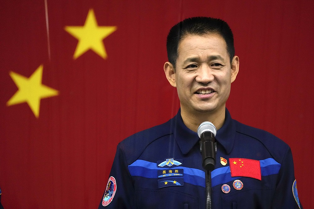 Chinese astronaut Nie Haisheng speaks during a press conference at the Jiuquan Satellite Launch Center ahead of the Shenzhou-12 launch from Jiuquan in northwestern China, Wednesday, June 16, 2021. China plans on Thursday to launch three astronauts onboard the Shenzhou-12 spaceship, who will be the first crew members to live on China's new orbiting space station Tianhe, or Heavenly Harmony from the Jiuquan Satellite Launch Center in northwest China. (AP Photo/Ng Han Guan)