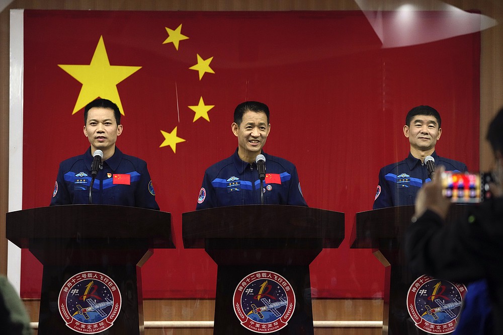 Chinese astronauts, from left, Tang Hongbo, Nie Haisheng, and Liu Boming attend a press conference at the Jiuquan Satellite Launch Center ahead of the Shenzhou-12 launch from Jiuquan in northwestern China, Wednesday, June 16, 2021. China plans on Thursday to launch three astronauts onboard the Shenzhou-12 spaceship, who will be the first crew members to live on China's new orbiting space station Tianhe, or Heavenly Harmony from the Jiuquan Satellite Launch Center in northwest China. (AP Photo/Ng Han Guan)