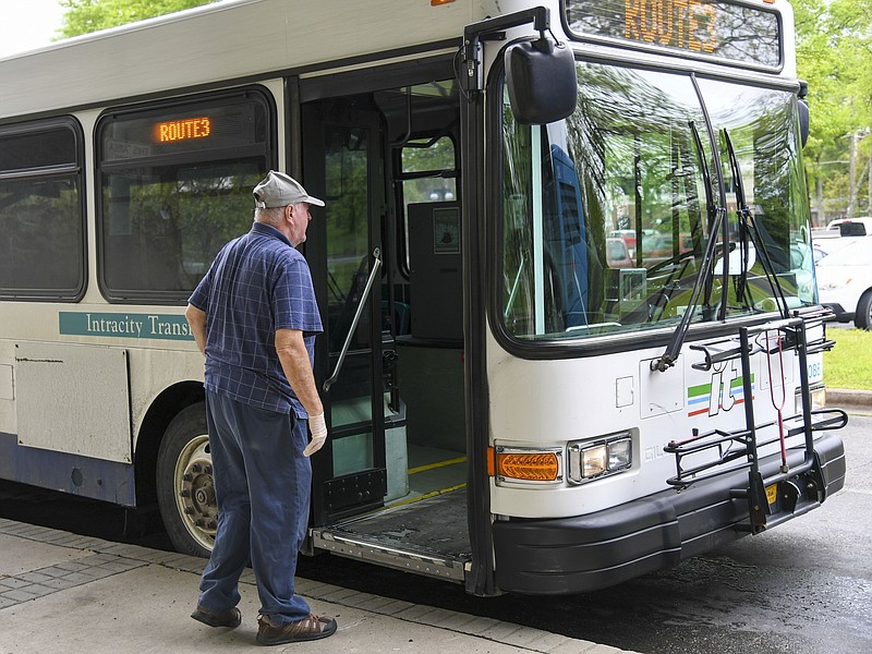 A rider boards a city bus at Transportation Plaza in April 2020. - File photo by The Sentinel-Record