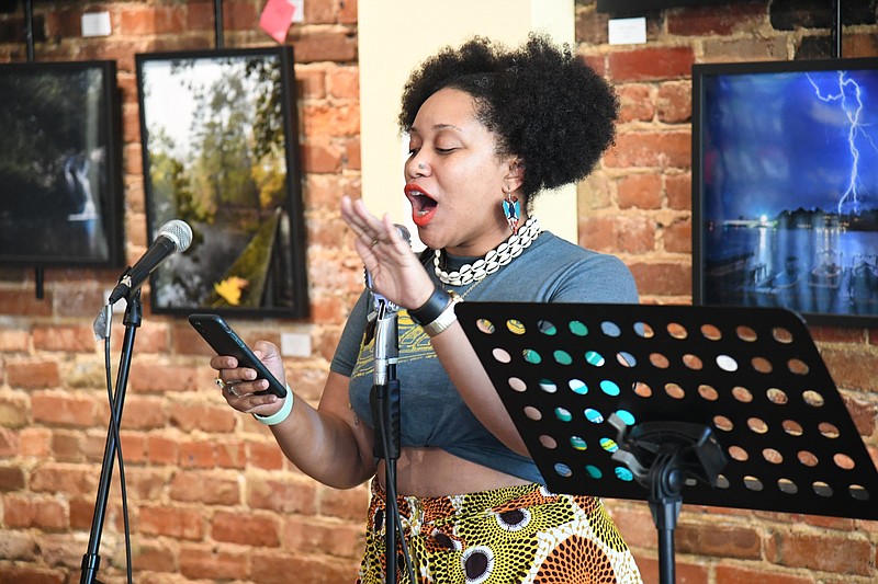 Crystal C. Mercer hits the stage during open mic at the first in-person Wednesday Night Poetry at Kollective Coffee+Tea in over a year. - Photo by Tanner Newton of The Sentinel-Record