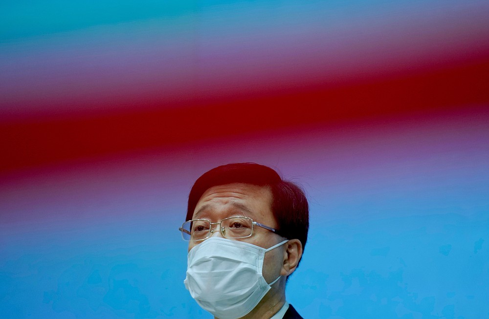 Hong Kong Secretary for Security John Lee listens to questions during a press conference in Hong Kong, Thursday, June 17, 2021. Hong Kong police used a sweeping national security law against the pro-democracy Apple Daily newspaper for the first time Thursday, arresting five editors and executives over articles calling for sanctions against people in Hong Kong and China. (AP Photo/Vincent Yu)