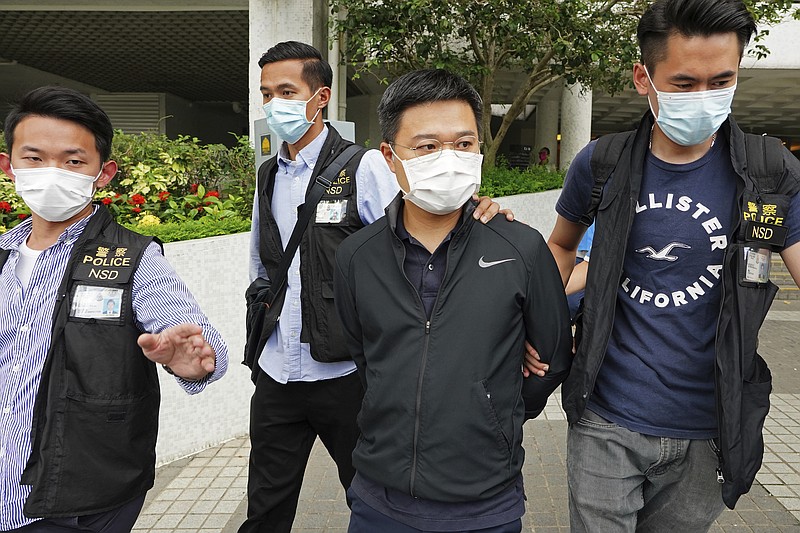 Ryan Law, second from right, Apple Daily's chief editor, is arrested by police officers in Hong Kong onThursday. Hong Kong police on Thursday morning arrested the chief editor and four other senior executives of Apple Daily under the national security law on suspicion of collusion with a foreign country to endanger national security, according to local media reports. Local media, including the South China Morning Post and Apple Daily, reported Thursday that national security police arrested Apple Daily's chief editor Ryan Law. - AP Photo