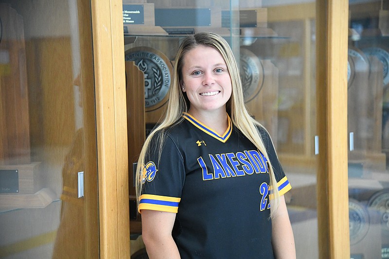 Erika Bittinger stands in front of a trophy case at Lakeside. - Photo by Tanner Newton of The Sentinel-Record