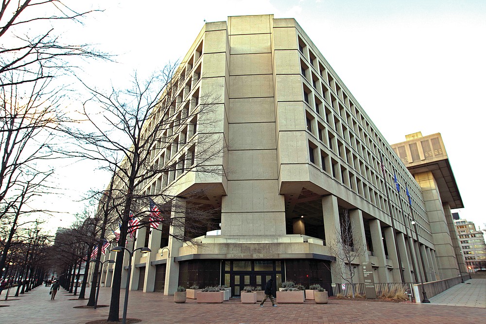 This Friday, Feb. 2, 2018 file photo shows the Federal Bureau of Investigation building in Washington. On Friday, June 18, 2021, The Associated Press reported on a video circulating online incorrectly asserting the FBI headquarters building in Washington is completely closed, empty and walled off. A video spreading the false claim shows the back of the building rather than the main entrance, which was open and fully operational this week, according to a statement from the FBI and the observations of an AP reporter based nearby. (AP Photo/Jose Luis Magana, File)