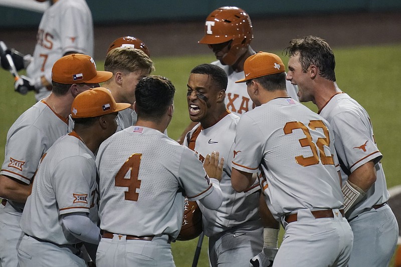 Texas’ Camryn Williams, center, celebrates a two-run homer against South Florida during the seventh inning of Sunday's NCAA Super Regional game in Austin, Texas. - Photo by Eric Gay of The Associated Press