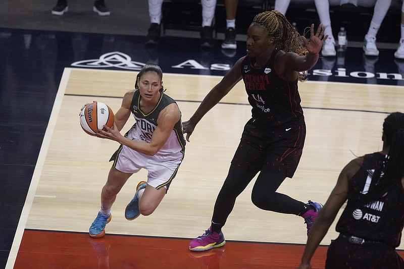 Seattle Storm's Sue Bird drives as Indiana Fever's Jantel Lavender defends during the second half of Thursday's game in Indianapolis. - Photo by Darron Cummings of The Associated Press