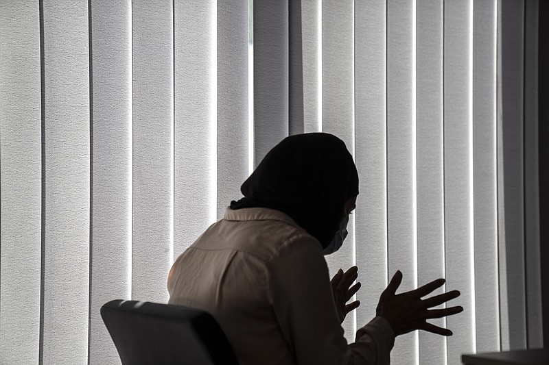 Huda Zaga, a Palestinian woman, speaks during an interview with The Associated Press, in Samos island, Greece, on June 9. The woman and her three children apparently eluded Greek authorities after reaching Samos in April with nearly three dozen other migrants, who were returned to Turkey. The Zuga family applied for and were granted asylum, adding credence to allegations that summary deportations, known as pushbacks, are occurring, despite Greece’s denials. - AP Photo/Petros Giannakouris