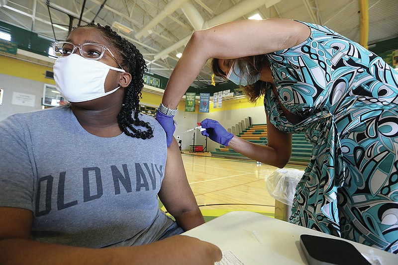Janessa Johnson, 13, gets her covid-19 vaccine shot from nurse practitioner Barbara McDonald on Friday, June 18, 2021, at University of Arkansas for Medical Science's vaccine clinic at Philander Smith College in Little Rock. (Arkansas Democrat-Gazette/Thomas Metthe)