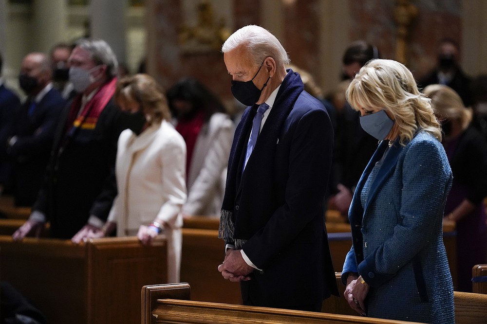 FILE - In this Wednesday, Jan. 20, 2021 file photo, President-elect Joe Biden and his wife, Jill Biden, attend Mass at the Cathedral of St. Matthew the Apostle during Inauguration Day ceremonies in Washington. When U.S. Catholic bishops hold their next national meeting in June 2021, they’ll be deciding whether to send a tougher-than-ever message to President Joe Biden and other Catholic politicians: Don’t partake of Communion if you persist in public advocacy of abortion rights. (AP Photo/Evan Vucci, File)