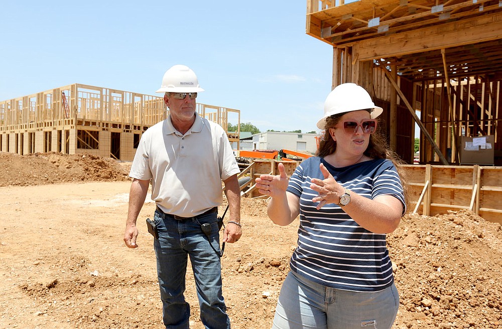 Sarah King (right), communications manager at Specialized Real Estate Group, and Shaun Brock, project superintendent with Huffman and Company, discuss the amenities Thursday, June 17, 2021, that will be available at the South Yard as they walk through a phase of the apartment construction on the site in Fayetteville. The project lies between elements of the city's U.S. 71B corridor project to the east and the University of Arkansas Windgate Art and Design District to the west, and plans to open apartments for lease early next year. Check out nwaonline.com/210620Daily/ and nwadg.com/photos for a photo gallery.
(NWA Democrat-Gazette/David Gottschalk)