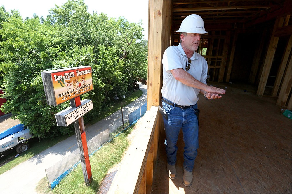 Shaun Brock, project superintendent with Huffman and Company, discusses Thursday, June 17, 2021, the decision to keep the Los Tres Hermanos Mexican Restaurant sign that was formerly located on the site of the South Yard as he walks through a phase of the apartment construction on the site in Fayetteville. The project lies between elements of the city's U.S. 71B corridor project to the east and the University of Arkansas Windgate Art and Design District to the west, and plans to open apartments for lease early next year. Check out nwaonline.com/210620Daily/ and nwadg.com/photos for a photo gallery.
(NWA Democrat-Gazette/David Gottschalk)