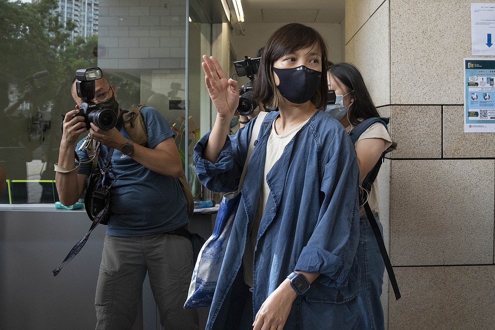 CAPTION CORRECTS JOB TITLE Chan Pui-man, associate publisher of Apple Daily newspaper, walks out from court in Hong Kong, Saturday, June 19, 2021. A Hong Kong court ordered the top editor of pro-democracy newspaper Apple Daily and the head of its parent company held without bail Saturday in the first hearing since their arrest two days ago under the city's national security law. Chan was one of the five Apple Daily staffs who were arrested by police on Thursday, but she was released on bail Friday. (AP Photo/Kin Cheung)