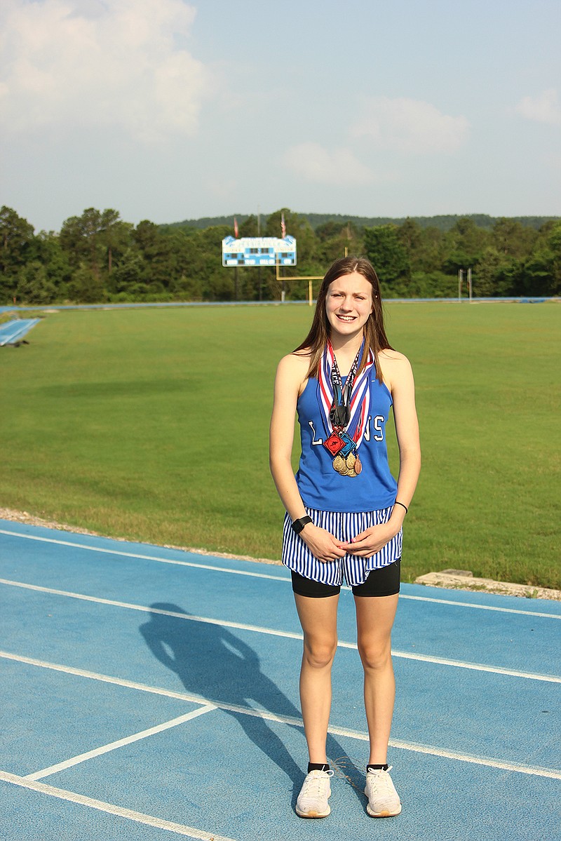 Jessieville sophomore Juliah Rodgers displays medals that she has won on the track at Don Phillips Field on June 10. - Photo by James Leigh of The Sentinel-Record