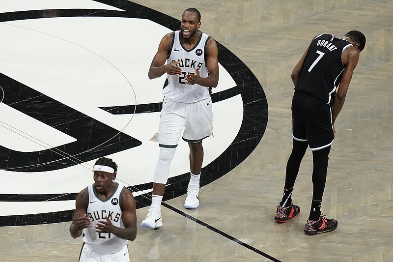 Brooklyn Nets' Kevin Durant (7) reacts after missing a shot as Milwaukee Bucks' Khris Middleton (22) and Jrue Holiday (21) talk to their bench Saturday during overtime of Game 7 of a second-round NBA playoff series in New York. - Photo by Frank Franklin II of The Associated Press