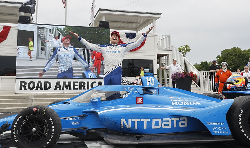 Alex Palou celebrates his victory in an IndyCar race at Road America in Elkhart Lake, Wisc., Sunday, June 20, 2021. (AP Photo/Jeffrey Phelps)