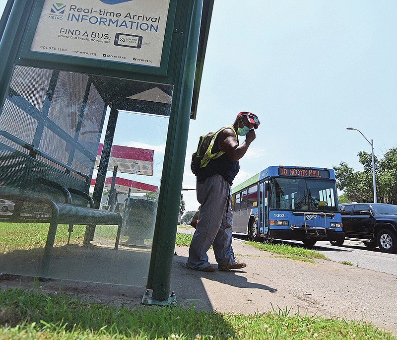 Wendell Martin of North Little Rock pulls his mask over his face before boarding a Rock Region Metro bus Friday, June 18, 2021 in North Little Rock.
(Arkansas Democrat-Gazette/Staci Vandagriff)