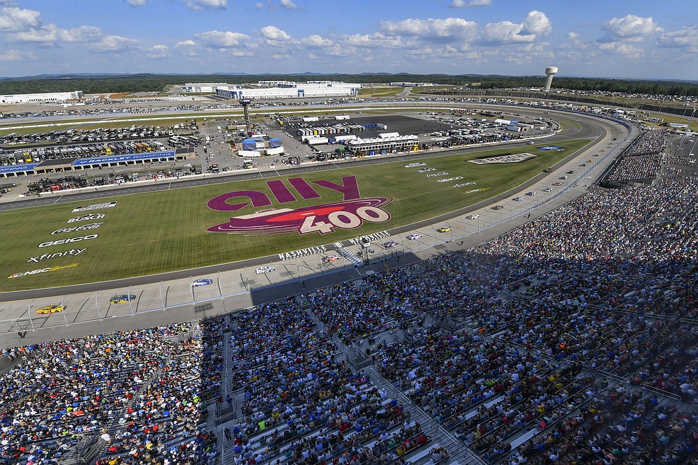 Fans watch a NASCAR Cup Series auto race Sunday, June 20, 2021, in Lebanon, Tenn. It is the first NASCAR race after an almost 10-year hiatus from Nashville Superspeedway. (AP Photo/John Amis)