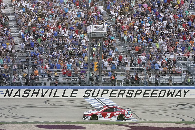 Kyle Larson (5) crosses the finish line to win a NASCAR Cup Series auto race at Nashville Superspeedway Sunday, June 20, 2021, in Lebanon, Tenn. (AP Photo/Mark Humphrey)