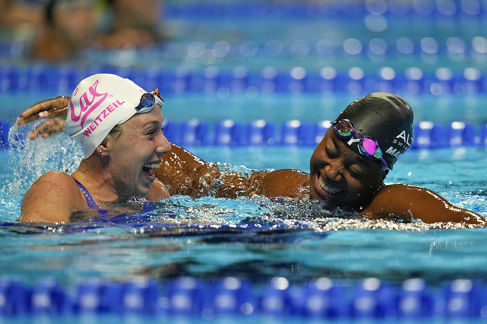 Simone Manuel and Abbey Weitzeil react after the women's 50 freestyle during wave 2 of the U.S. Olympic Swim Trials on Sunday, June 20, 2021, in Omaha, Neb. (AP Photo/Jeff Roberson)