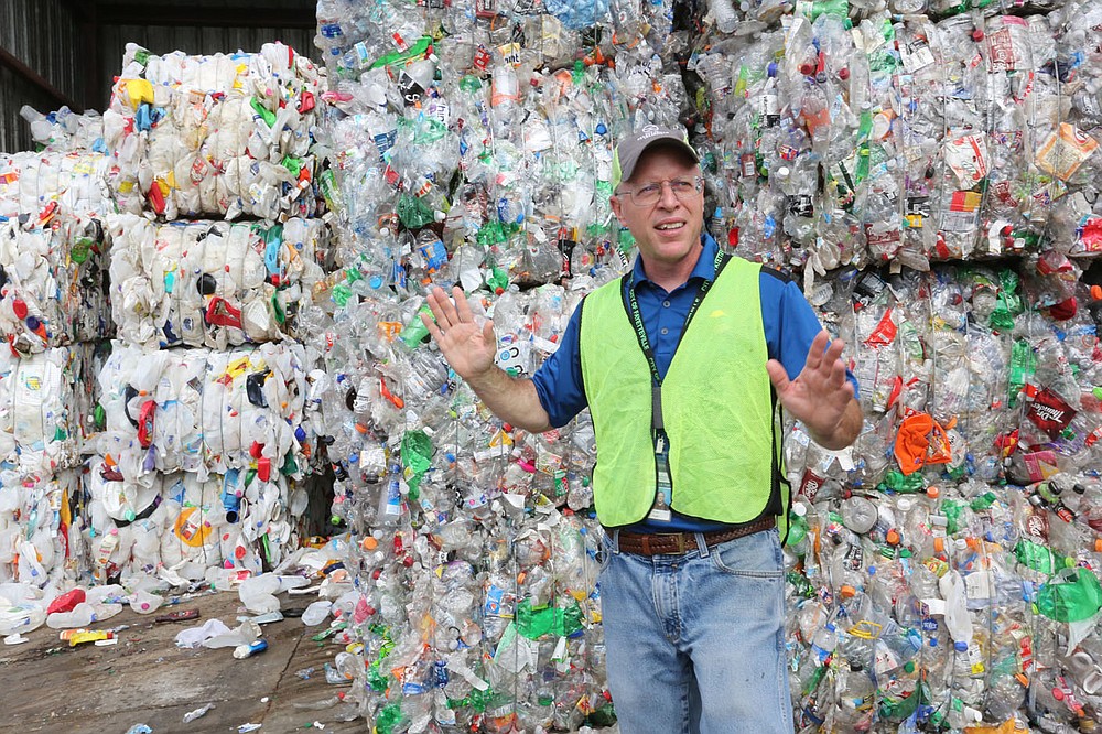 Brian Pugh, waste reduction coordinator with the city of Fayetteville, describes Friday, June 11, 2021, the demand for both number 1 and 2 plastic bottles at the Material Recovery Facility for the Recycling and Trash Collection Division for the city. The Northwest Arkansas Council is proposing a circular economy that makes use of regional recycling programs to create new businesses and jobs and reduce waste. Check out nwadg.com/photos for a photo gallery.
(NWA Democrat-Gazette/David Gottschalk)