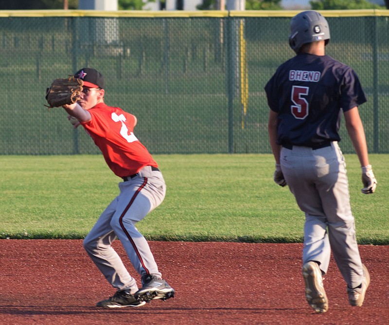 RICK PECK/SPECIAL TO MCDONALD COUNTY PRESS McDonald County second baseman Asher Hutchinson throws to first base after forcing a Joplin runner out at second base during the McDonald County 14U baseball team's 7-7 tie with Joplin on June 17 at Wendell Redden Stadium in Joplin.