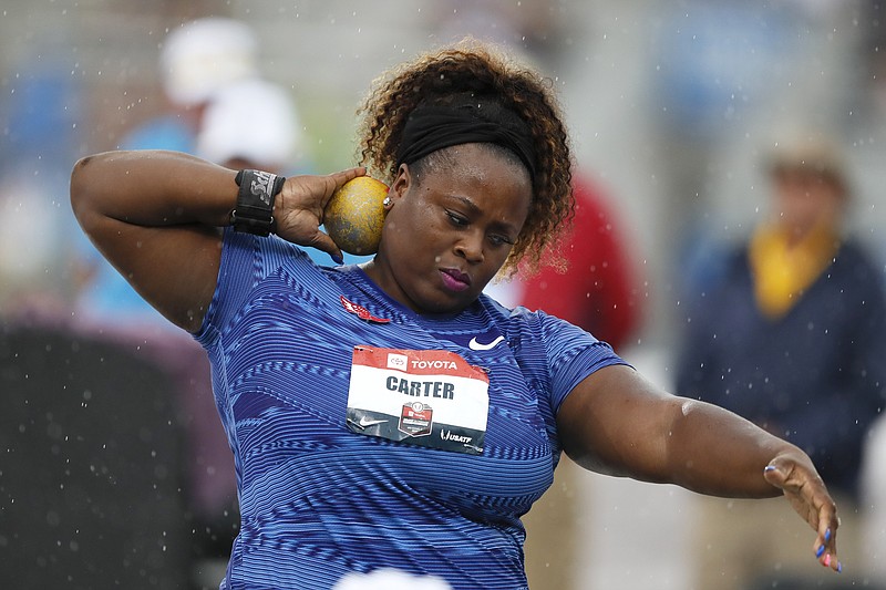 FILE - Michelle Carter sets to throw during the women's shot put at the U.S. Championships athletics meet in Des Moines, Iowa, in this Sunday, July 28, 2019, file photo. Reigning Olympic shot put champion Michelle Carter won't compete at the U.S. track and field trials after having a benign tumor removed from her right ankle. The 35-year-old will cheer on her friends and fellow competitors. (AP Photo/Charlie Neibergall, File)