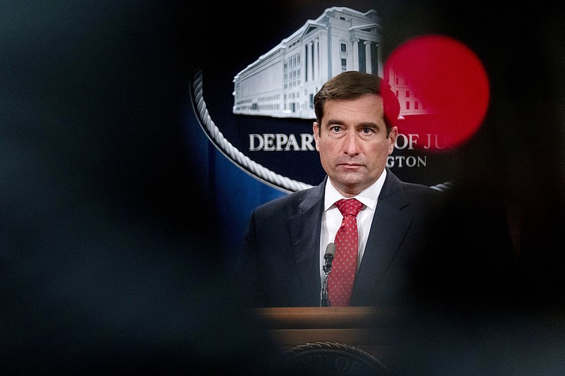 FILE - In this Oct. 19, 2020, file photo Assistant Attorney General for the National Security Division John Demers takes a question from a reporter via teleconference at a news conference at the Department of Justice in Washington. The damned-if-you-pay-damned-if-you-don’t dilemma on ransomware payments has left U.S. officials fumbling about how to respond. In April, the then-top national security official in the Justice Department, John Demers, was lukewarm toward banning payments, saying it could put “us in a more adversarial posture vis-à-vis the victims, which is not where we want to be.”  (AP Photo/Andrew Harnik, Pool)